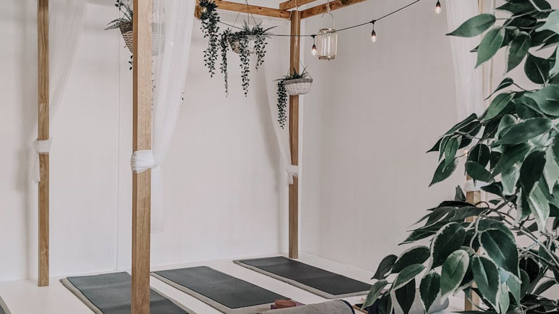Peaceful yoga studio interior with soft sunlight and wooden floors